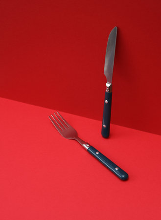 Fork and knife on red backgroundの写真素材