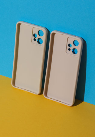 White Protective cases for smartphones on yellow blue backgroundの写真素材