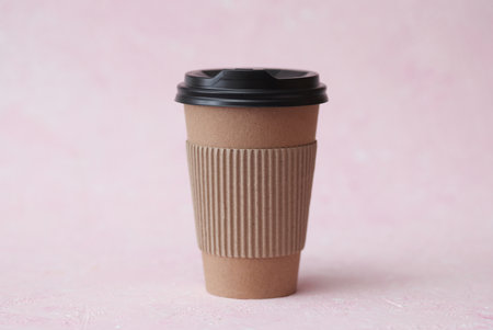 Craft cardboard coffee cup on pink concrete backgroundの写真素材