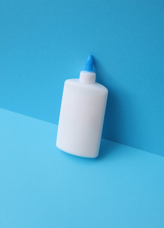 Bottle of pva glue on blue backgroundの写真素材