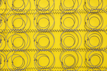 Bed springs on yellow background close upの写真素材