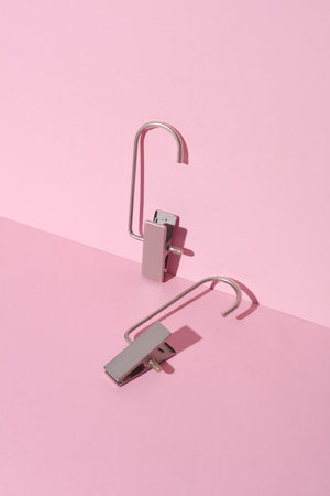 Hangers for trousers and jeans on a pink backgroundの写真素材