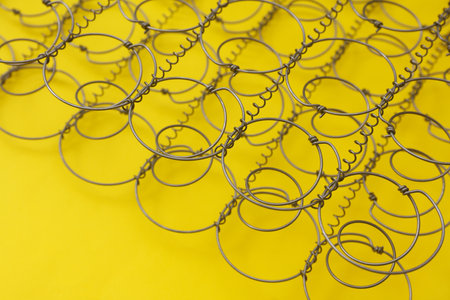Bed springs on yellow background close upの写真素材