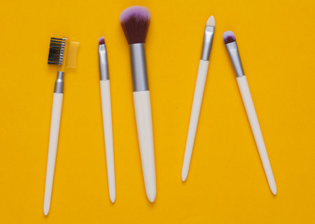 Set of makeup brushes on a yellow backgroundの写真素材