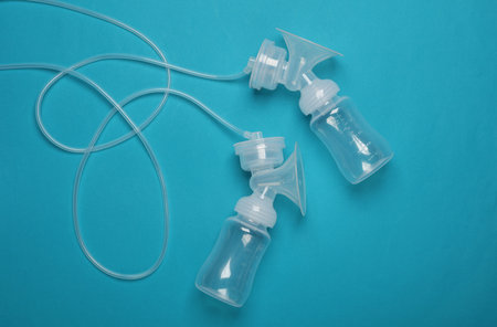 Breast pump bottles on blue background