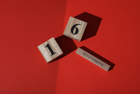 Wooden calendar with the date November 16 on a red background
