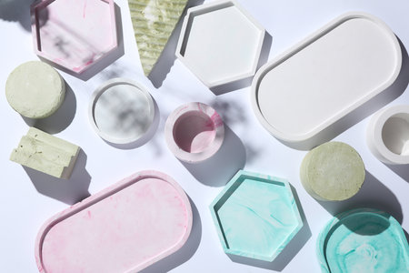 Set of Decorative pink plaster trays of different shapes on white background with shadows. Stands...