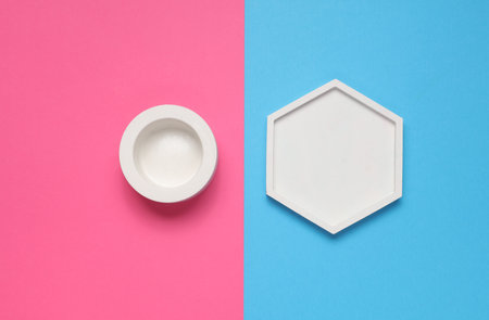Hexagonal and round plaster tray on a pink blue background. Top viewの写真素材
