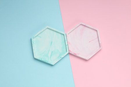Hexagonal plaster trays on pink blue background. Top viewの写真素材