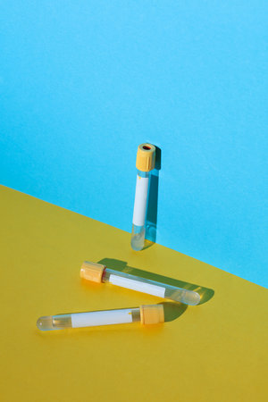 Empty test tubes on a blue-yellow backgroundの写真素材