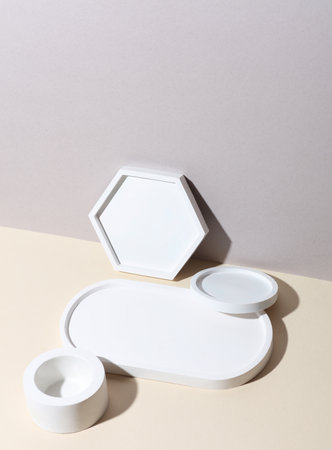 Decorative plaster trays on beige background. Stands for candles, organizers for cosmetics or jewelry.の写真素材