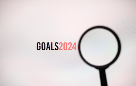 The word goals 2024 on white screen with a magnifying glass