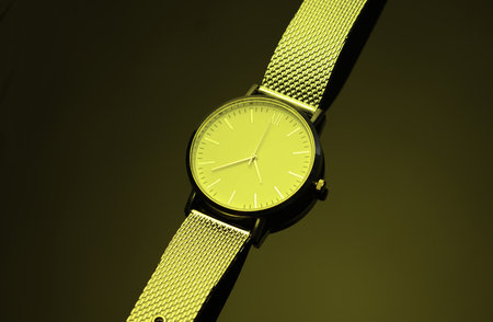 Women's wristwatch in yellow neon light