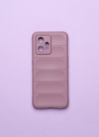 Smartphone protective cover on purple background. Top viewの写真素材