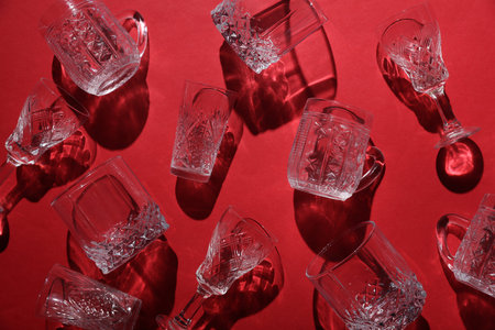 Drink glasses with shadow on red background. Top view. Minimalism, creative layoutの写真素材