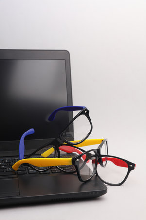 Laptop with Stylish fashion eyeglasses on a white background.の写真素材