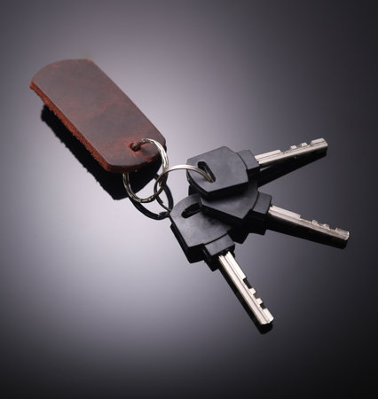 Keys with leather keychain on black backgroundの写真素材