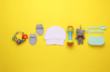 Accessories for newborn on yellow background. Top viewの写真素材