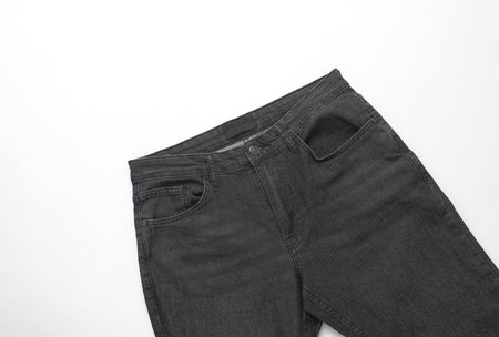 Dark gray men's jeans on a white backgroundの写真素材