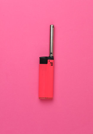 Household lighter on pink background. Top viewの写真素材