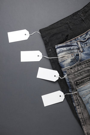 Many jeans pants with white price tags. Top viewの写真素材