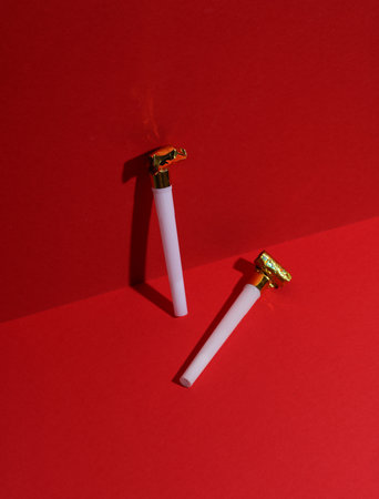 White birthday horns on red background