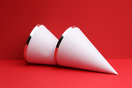 White birthday cones caps mockup on a red backgroundの写真素材