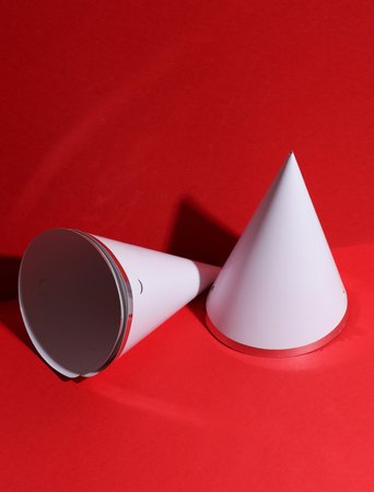 White birthday cones caps mockup on a red backgroundの写真素材
