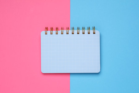 Notepad on a blue-pink background. Top viewの写真素材