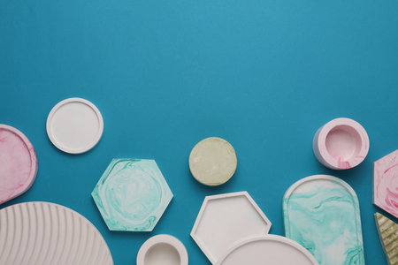 Plaster geometric shapes, decorative trays on blue background. Top viewの写真素材