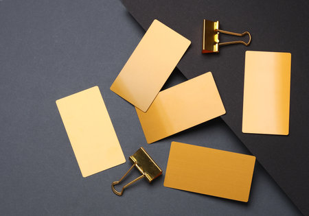 Gold business cards and binders on a dark backgroundの写真素材