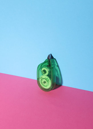 Stationery tape corrector on a blue-pink background. Creative layoutの写真素材