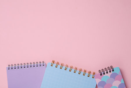 Various notepads on a pink background.の写真素材