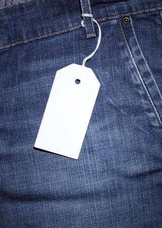 Blank price tag on blue jeans close upの写真素材