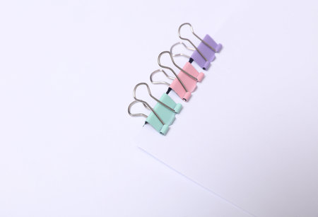 White blank sheet of paper with colored bindersの写真素材