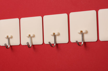 Wall hooks on a red background