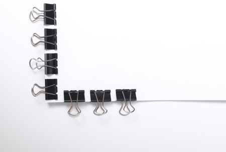 White blank sheet of paper with Black bindersの写真素材