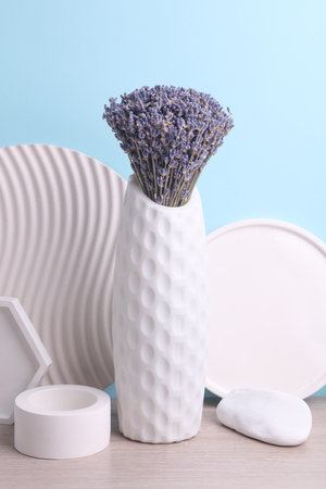 Dry lavender in a vase on a table and plaster shapes, blue background. Minimalism still lifeの写真素材