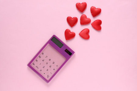 Calculator with hearts on a pink backgroundの写真素材