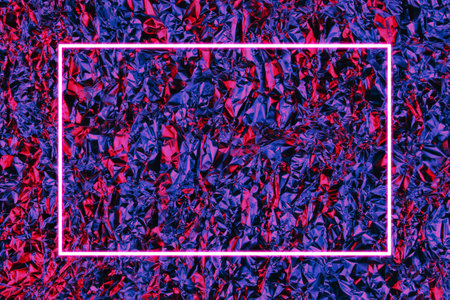 Texture of crumpled foil with neon blue pink lightの写真素材