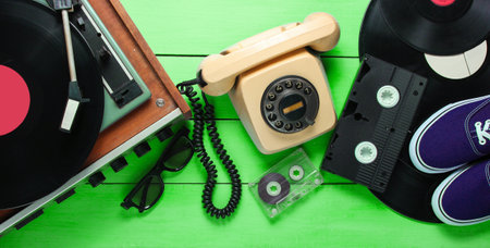 Old-fashioned objects on green wooden background. Retro style, 80s, pop culture. Top viewの写真素材