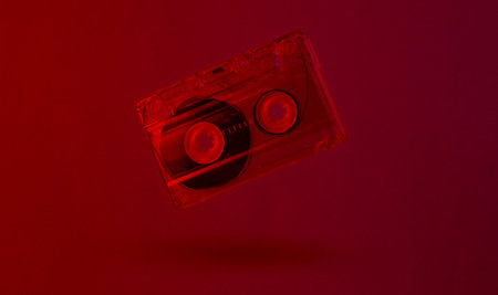 Minimalism retro style concept. 80s. Audio cassette in neon red light. Retro waveの写真素材