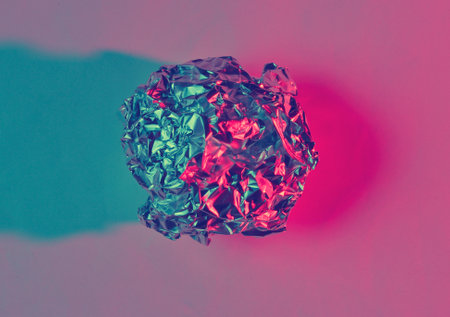 Crumpled paper ball enveloping neon blue pink light. Top view, surrealismの写真素材