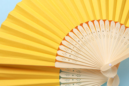 Traditional Asian yellow hand fans on blue backgroundの写真素材