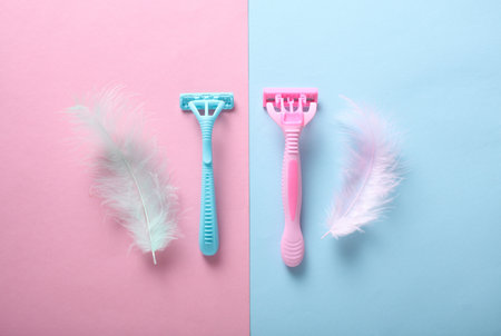 Depilatory razors with feathers on pink blue backgroundの写真素材