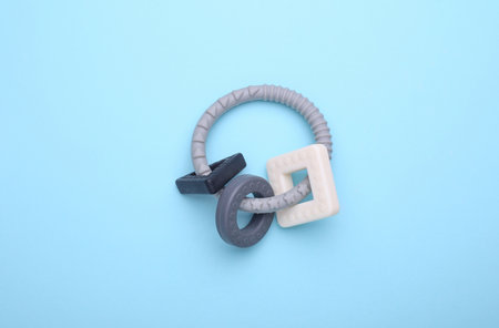 Teether, rattle for newborn on blue background