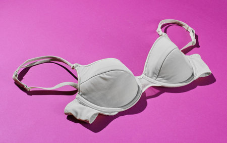 Comfortable women's bra on purple background. Beautiful underwear. Side viewの写真素材
