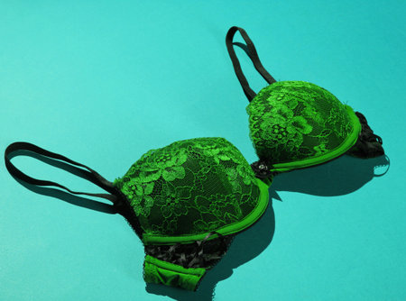 Female bra on blue background. Beautiful underwear. Side viewの写真素材