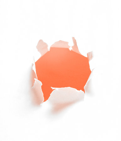Orange Hole of torn white paper. Copy space