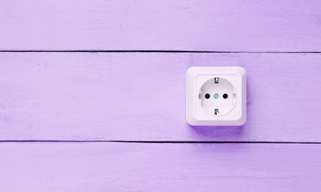 Power socket on purple wooden wall, minimalismの写真素材
